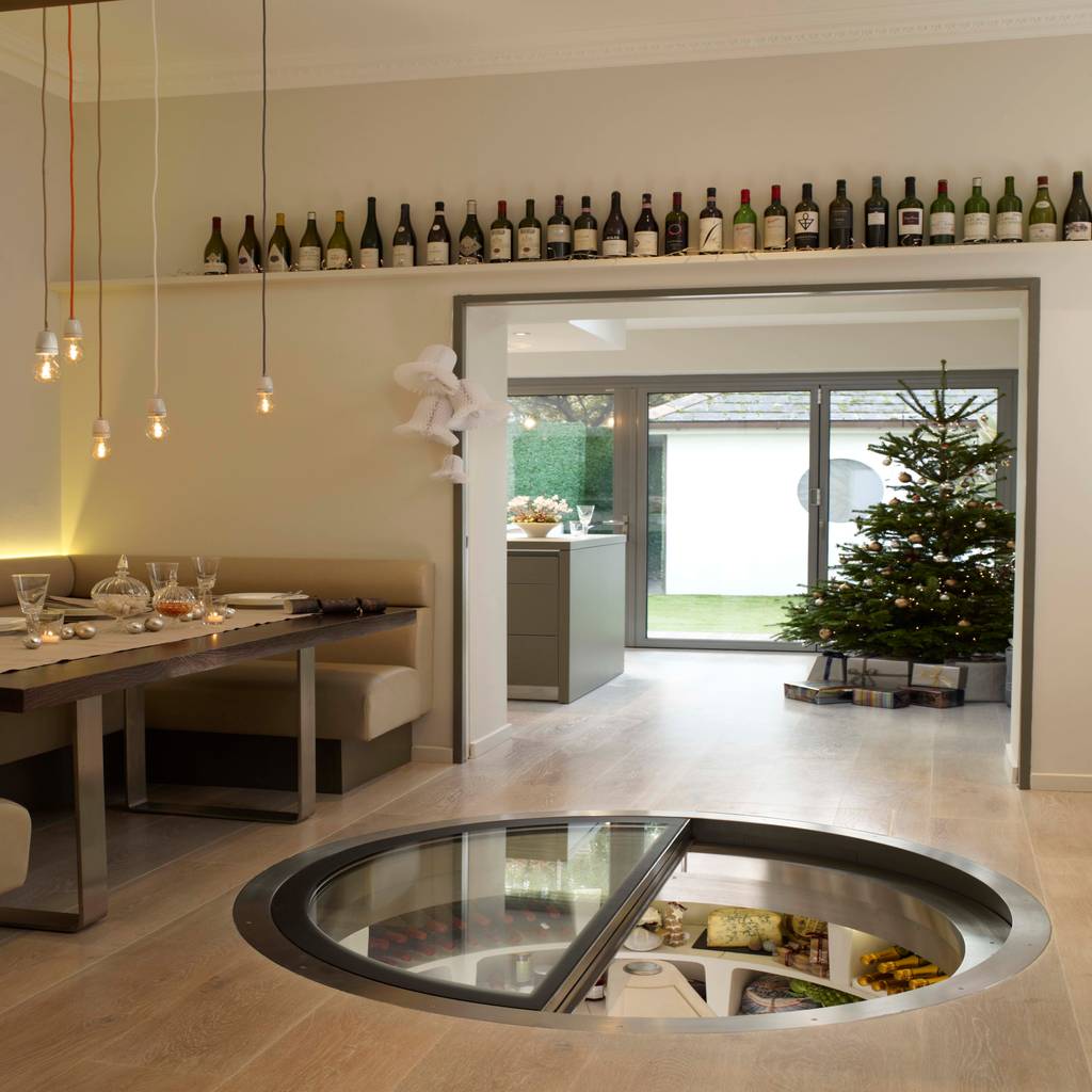 White spiral cellar with retractable round glass door homify modern wine cellar homify