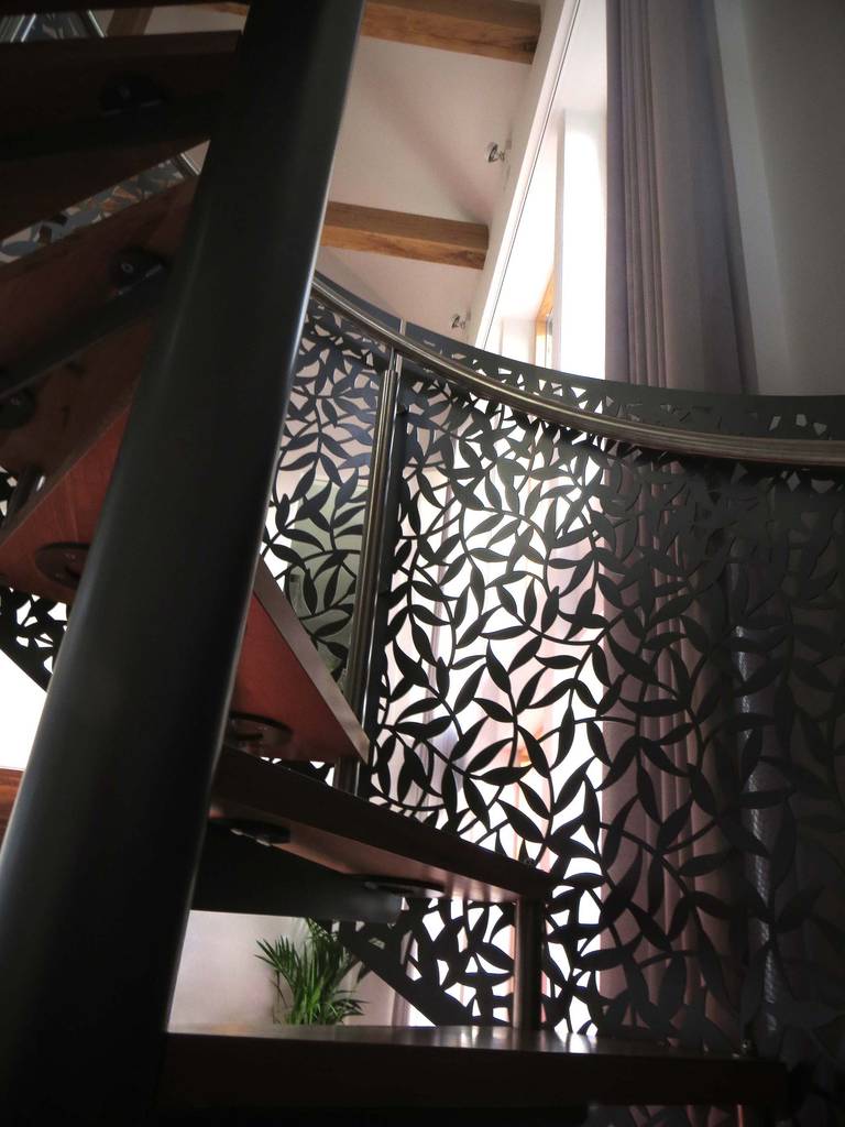 Laser cut screens—spiral staircase and mezzanine apron. | homify