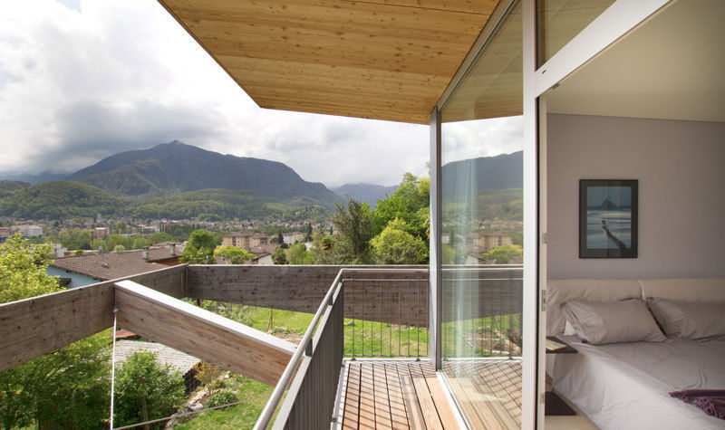 Casa Locarno // Balkon designyougo - architects and designers Mediterraner Balkon, Veranda & Terrasse Holz Holznachbildung Balkon,,schlafzimmer,aussicht,holz,dachüberstand,Glasfassade