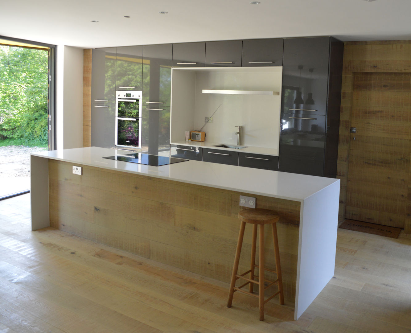 Open Plan Kitchen featuring a Bespoke Kitchen Island ArchitectureLIVE ห้องครัว kitchen island,kitchen appliances,kitchen floor,timber flooring,wood floor,concealed door,open-plan,1960s house,extension