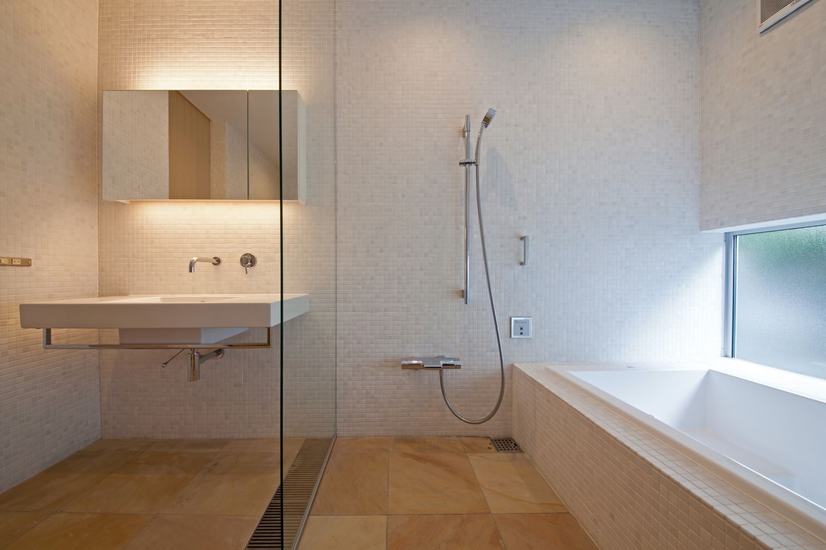 ホテルライクなバスルーム 根岸達己建築室 モダンスタイルの お風呂 大理石 白色 大理石モザイク,間接照明