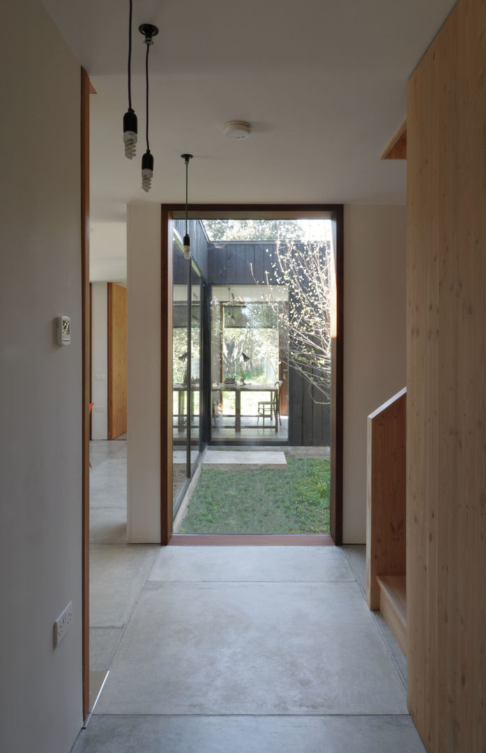 A Timber-Clad House Design on the Isle of Wight: The Sett, Dow Jones Architects Dow Jones Architects Minimalist corridor, hallway & stairs