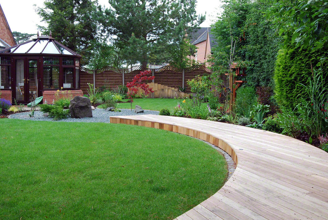A curved deck links the seating area to the house Lush Garden Design Asian style garden