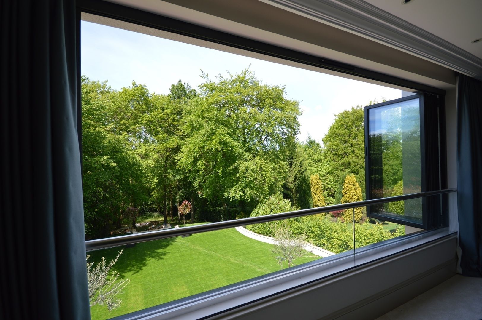 The master bedroom with bifold window Zodiac Design Modern style bedroom