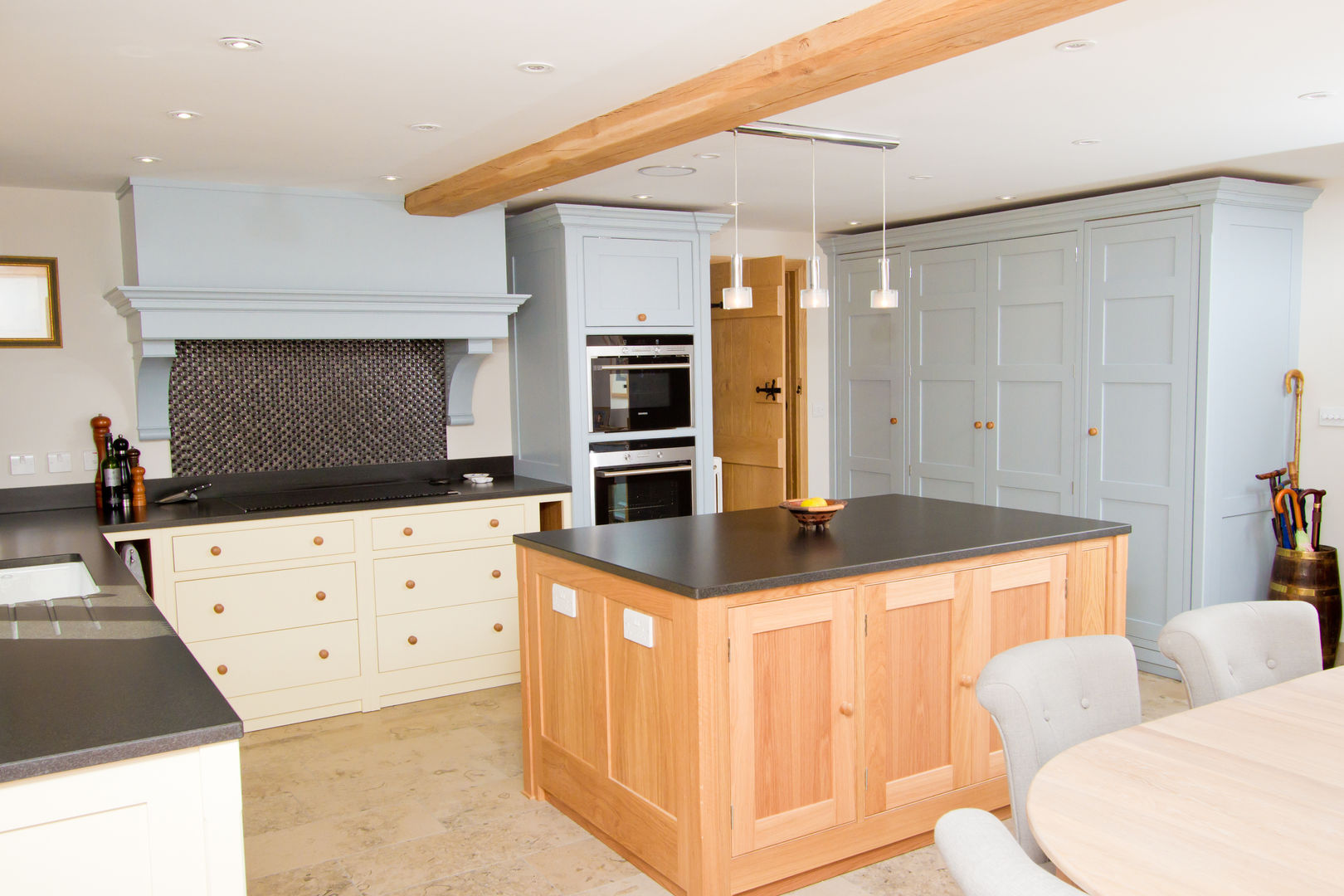 A kitchen of creams, pale blues and oaks Design by Deborah Ltd Country style kitchen Storage