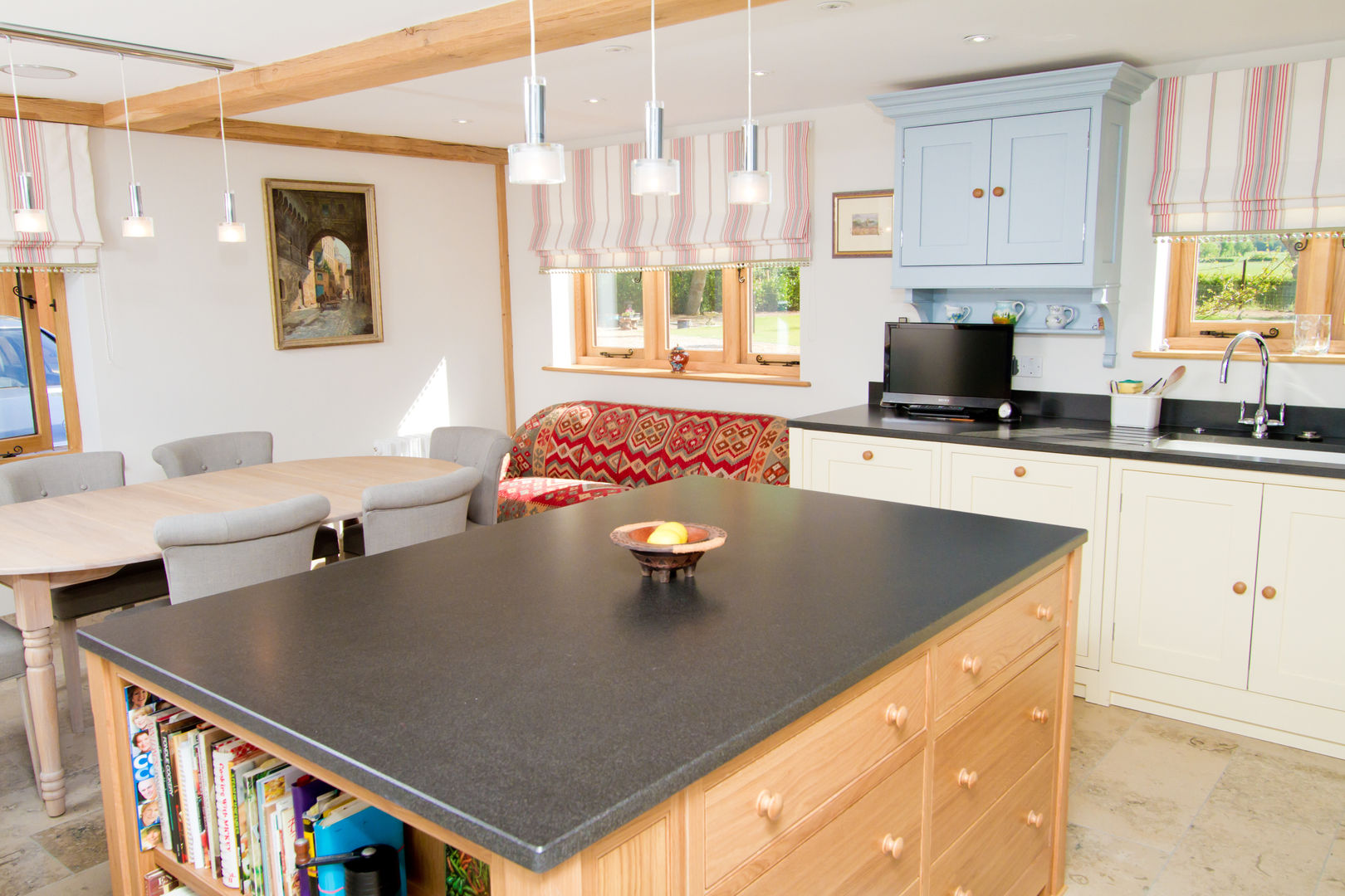 Granite kitchen island Design by Deborah Ltd Kitchen Cabinets & shelves