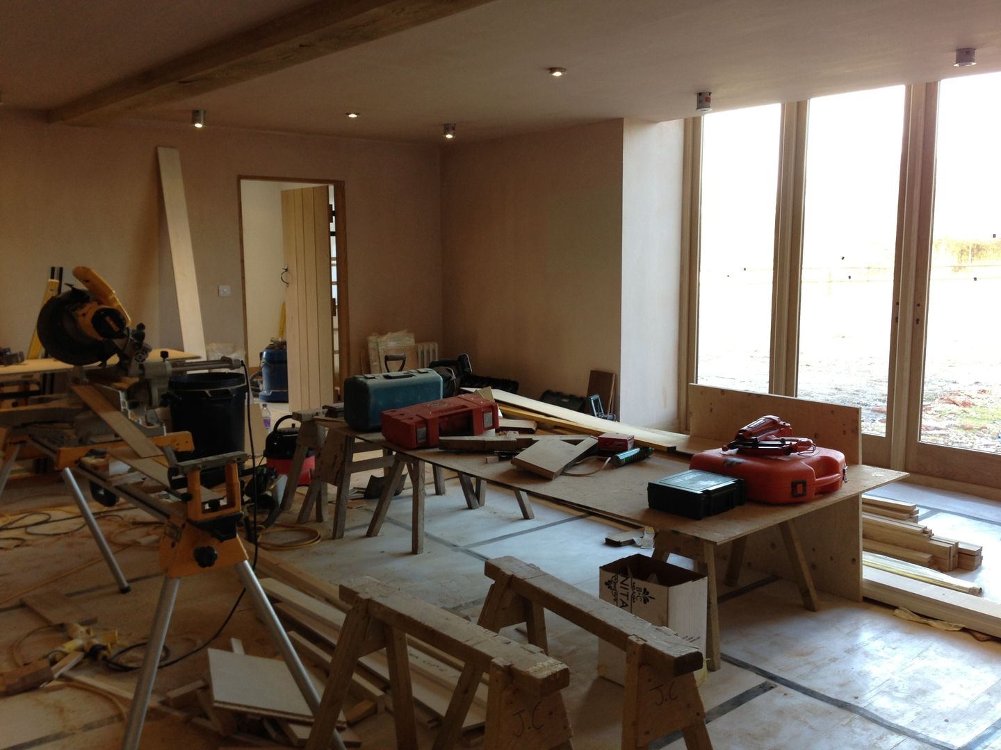 Barn Conversion - Living room freshly plastered and windows fitted Design by Deborah Ltd