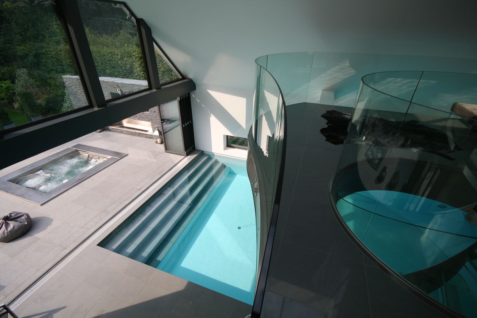 Indoor pool with waterfall features, sauna and stainless steel spa, Tanby Pools Tanby Pools Modern pool
