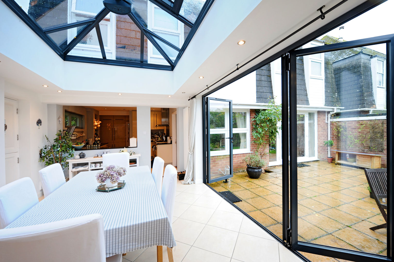 Orangery from kitchen with bi folding doors homify Modern conservatory