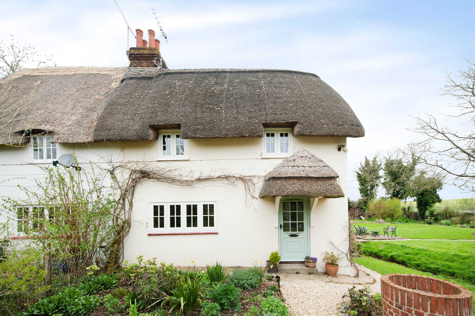 Thatch Cottage with Storm Evolution Windows homify Rustic style windows & doors