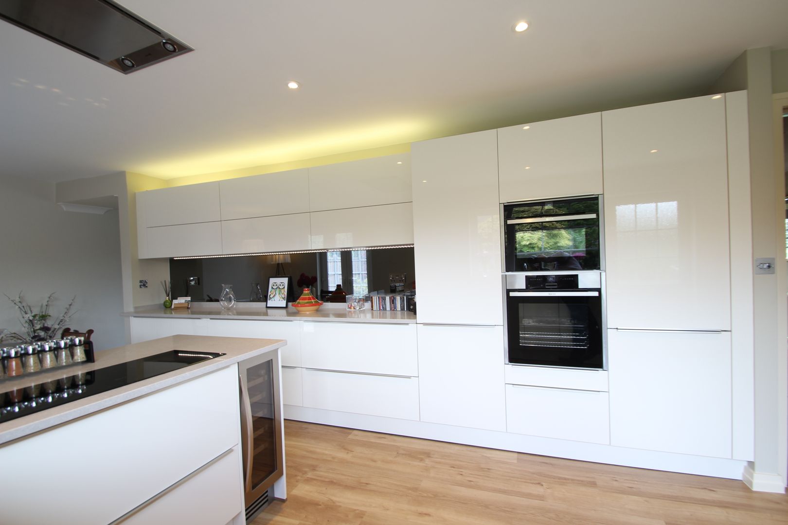 White gloss Schuller handled with Neff appliances and Ceaserstone worktops AD3 Design Limited Modern kitchen