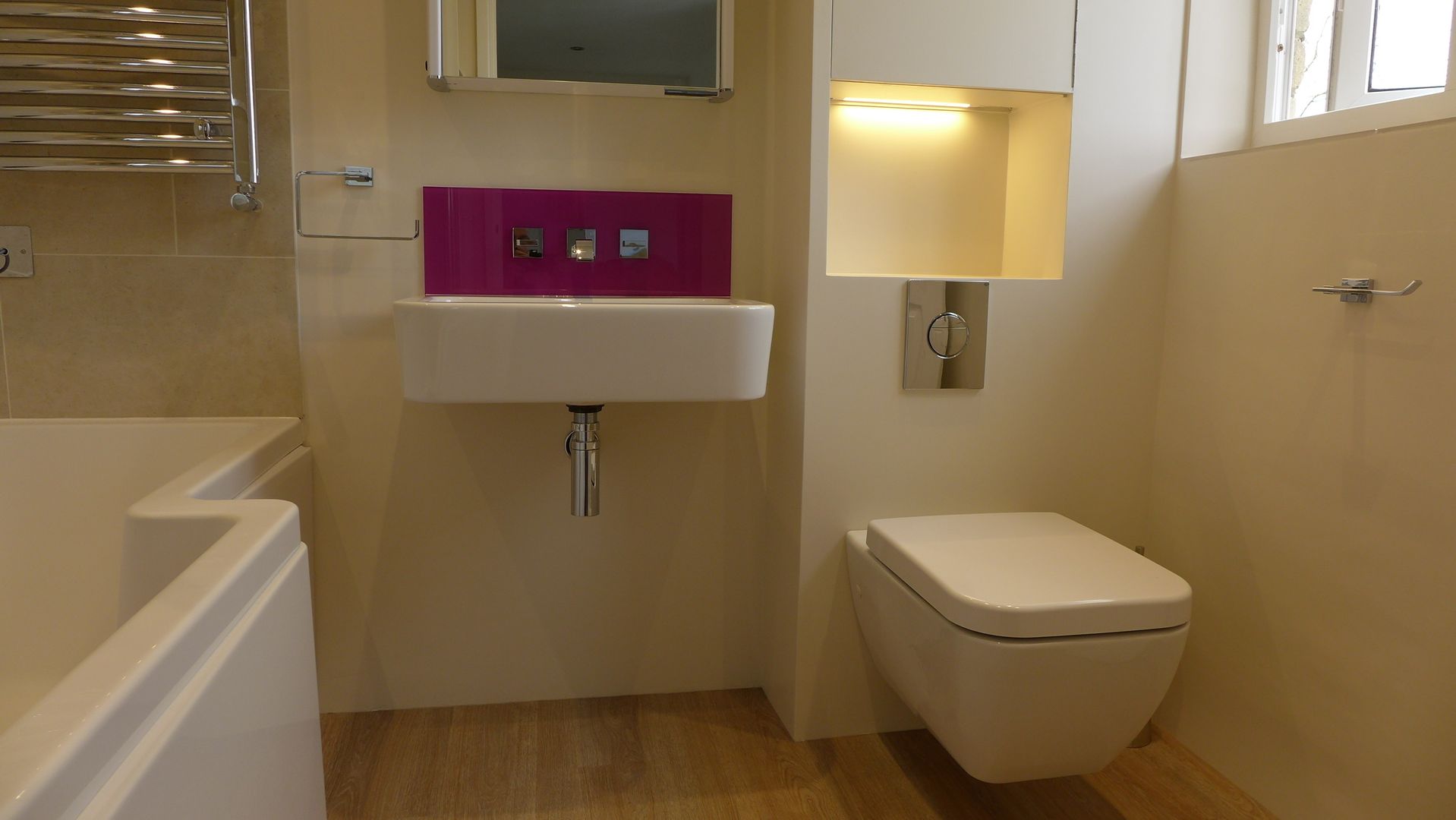 Wall mounted basin with pink purple glass splashback Style Within Modern Banyo modern bathroom,wall mounted taps,wall hung WC,bathroom storage,bathroom lighting,wall hung basin,mirror cabinet,vinyl plank floor,small bathroom