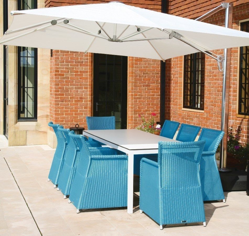 Rattan and Metal garden dining set with blue rattan armchairs and modern, white aluminium and glass table Ingarden Ltd حديقة أثاث