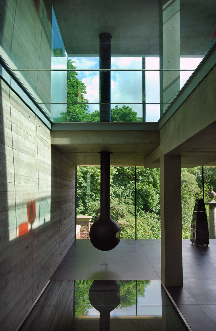 Hanging fireplace, glass floors, concrete structure and view to cemetery Eldridge London Living room