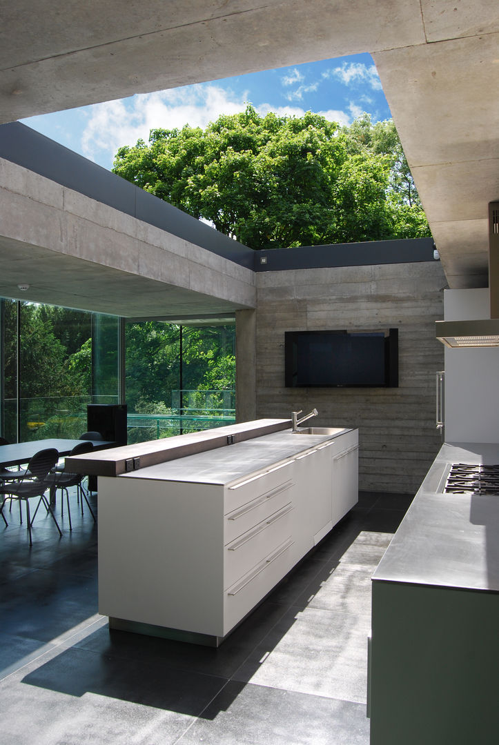 Kitchen with sliding rooflight to create open-air court Eldridge London Kitchen