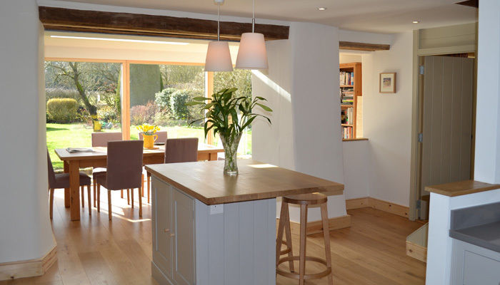 View from refurbished kitchen to garden room Hetreed Ross Architects Modern kitchen