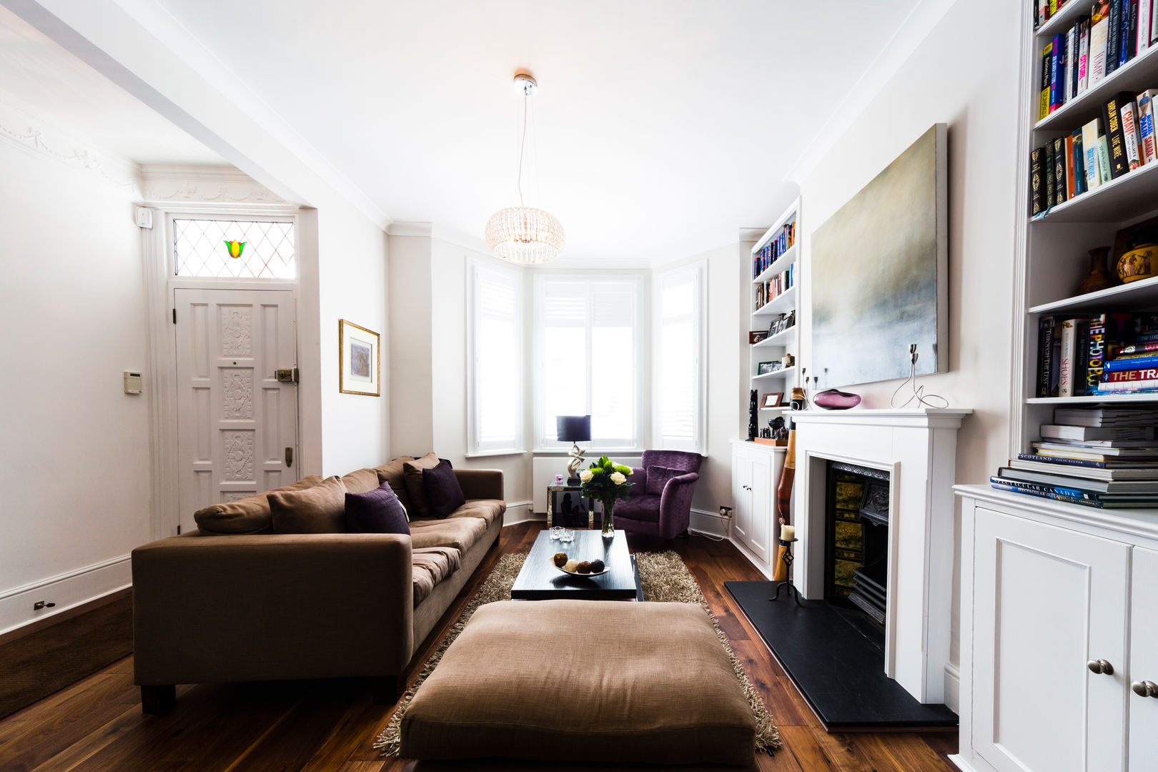 ​White Living Room with wooden floors, brown sofa, carpet and purple accents Affleck Property Services ห้องนั่งเล่น