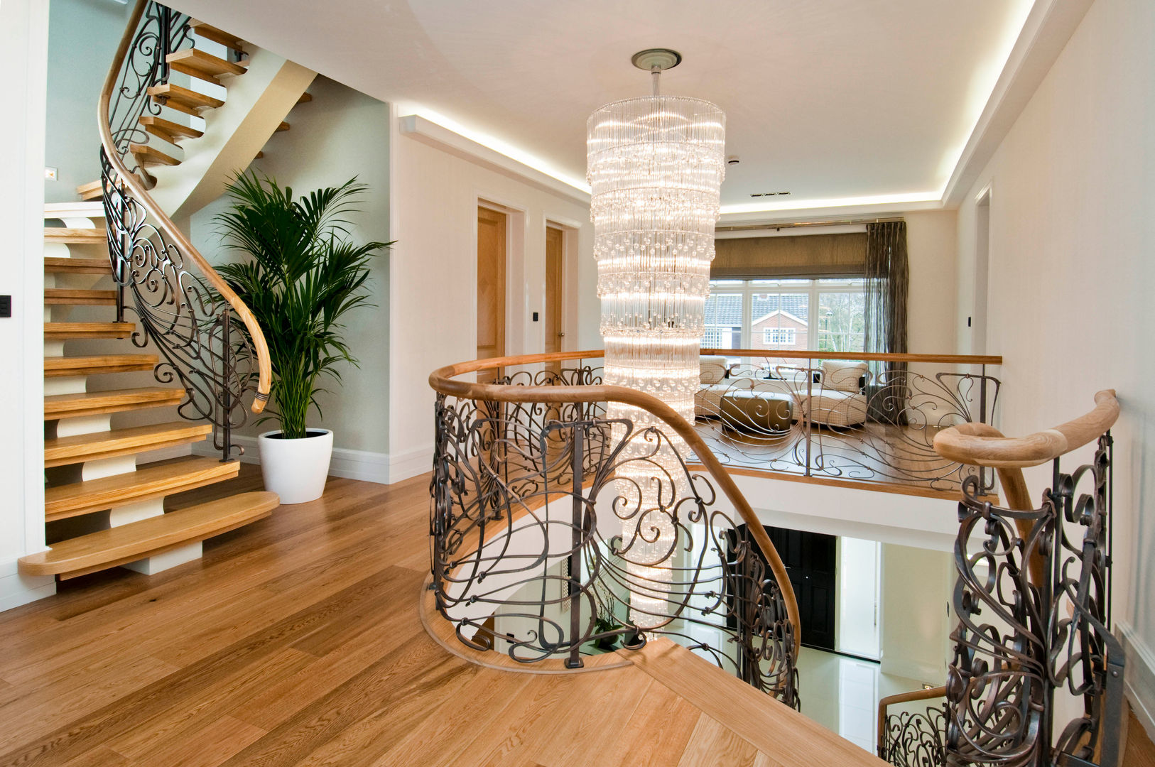 BESPOKE CHANDELIER AND STAIRCASE Shandler Homes Ltd Modern Corridor, Hallway and Staircase