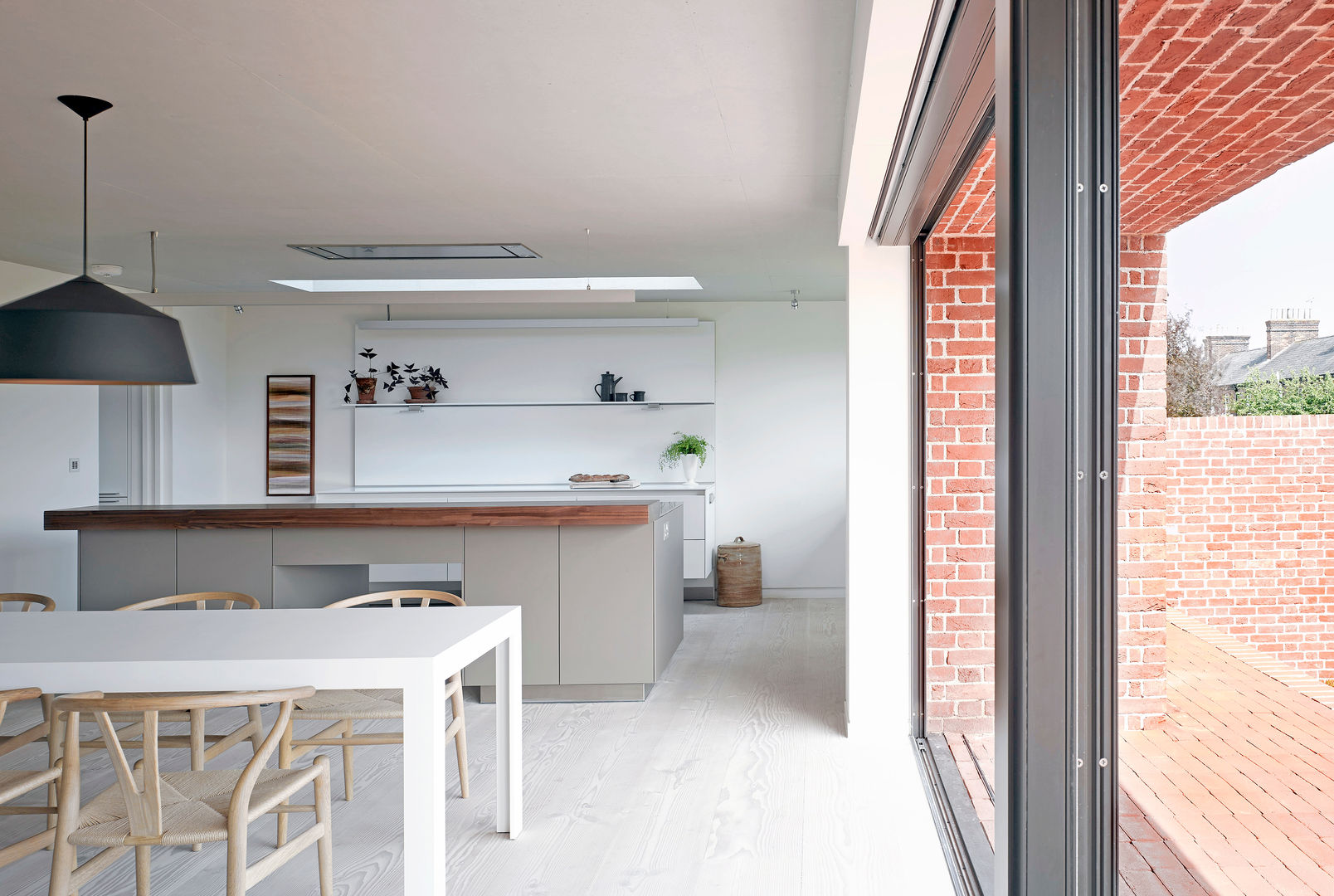 ​View of the kitchen from the dining area at the house at Broad Street in Suffolk Nash Baker Architects Ltd Nhà bếp phong cách hiện đại
