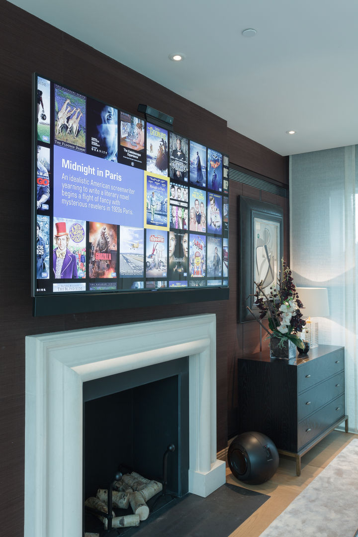 Wall mounted TV on electric bracket London Residential AV Solutions Ltd Modern style media rooms