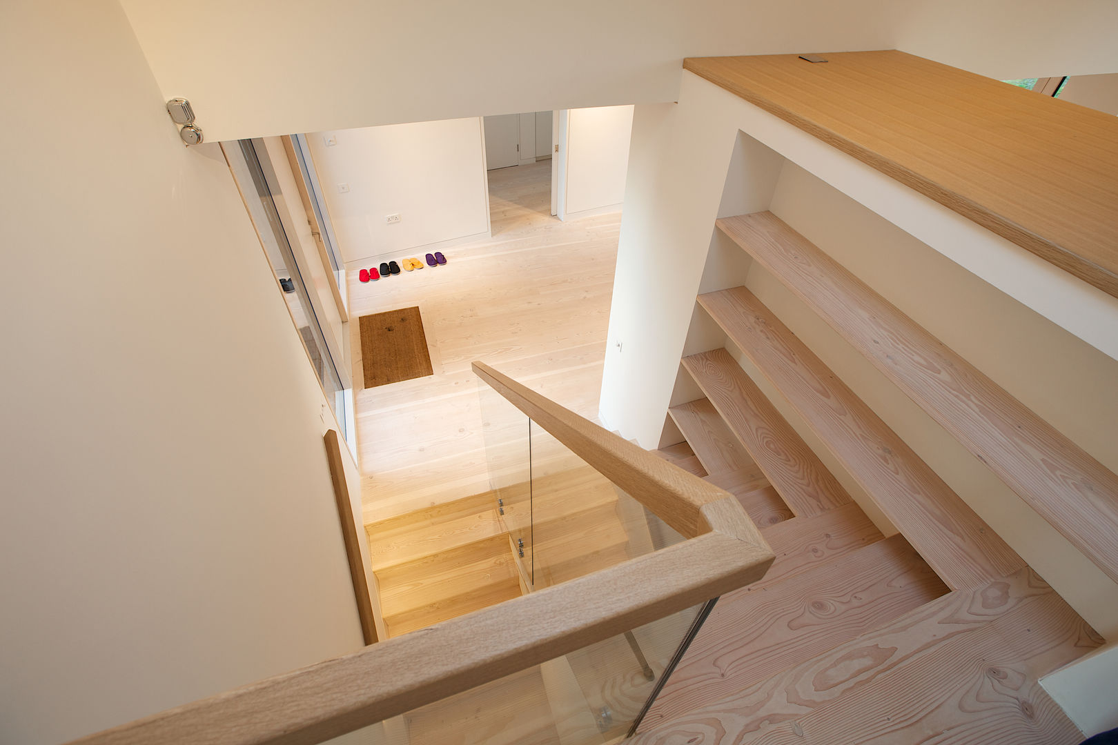 ​The Douglas Fir staircase and flooring in the hall at Bourne Lane House in Kent Nash Baker Architects Ltd Corredores, halls e escadas modernos Madeira Efeito de madeira