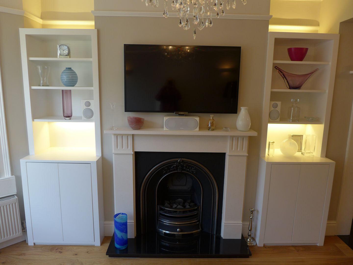 Built-in Alcove Storage Style Within Modern living room alcove storage,alcove units,alcove lighting,room lighting,accent lighting,TV over fireplace,hidden HIFi,bifold doors,gas fire,stone fire surround,alcove cabinets,white alcove units