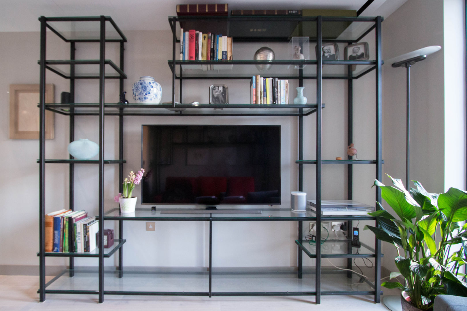 Glass and metal shelving unit Railing London Ltd Modern living room Steel unit with glass shelves.