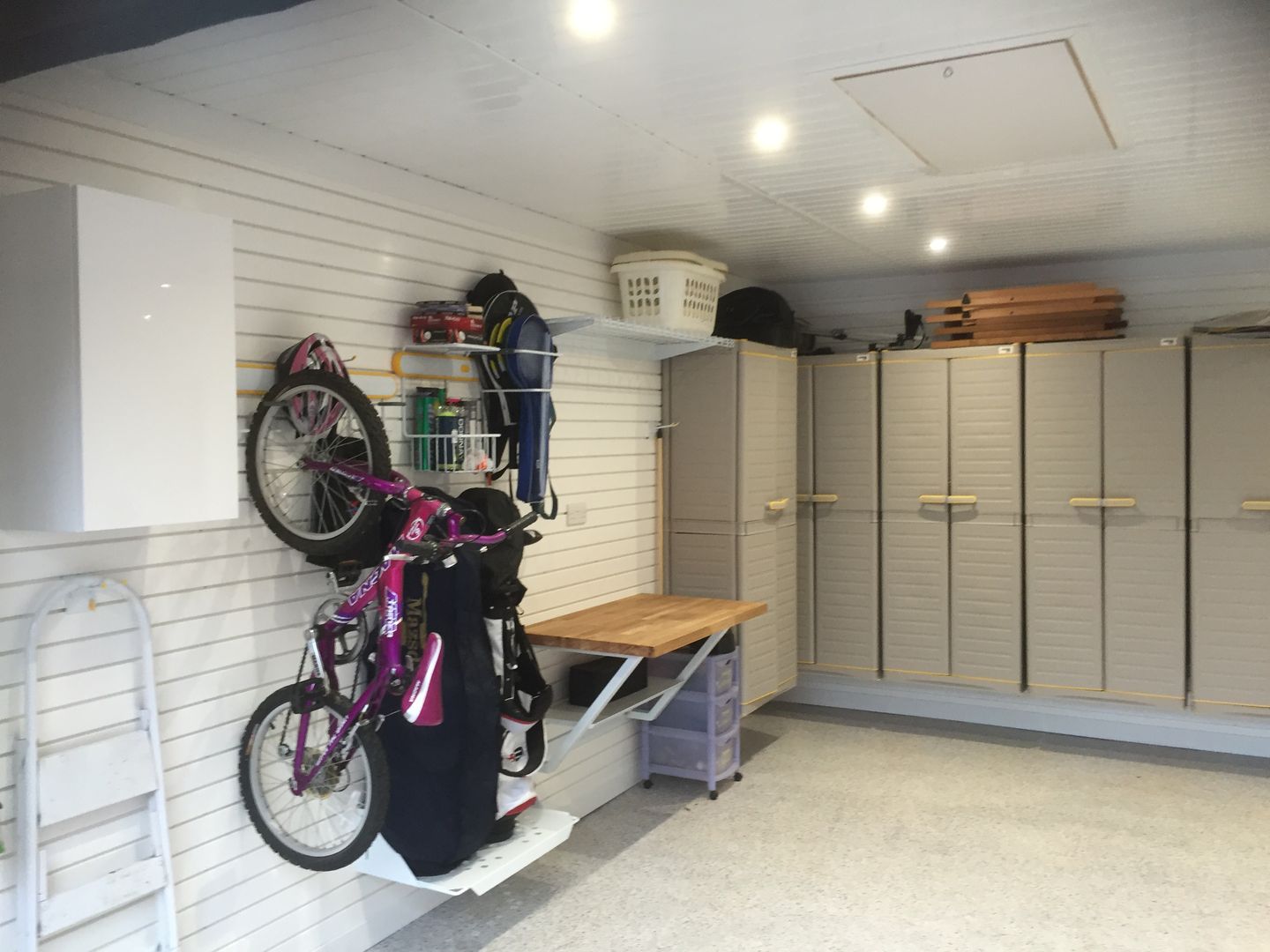 An Extraordinary Garage Makever with wall cabinets and bike storage Garageflex Garage/shed garage storage,wall storage,bike storage,golf,bikes,cycling,workbench,resin floor,garage floor,flooring,garage,garageflex