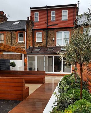 Addition of a Loft Conversion, Rear Extension with bi folding doors and a contemporary garden IS AND REN STUDIOS LTD loft conversion,extension,sash windows,contemporary garden,wooden bench,raised flower bed,raised planting,evergreens,olive trees,red cedar,victorian home