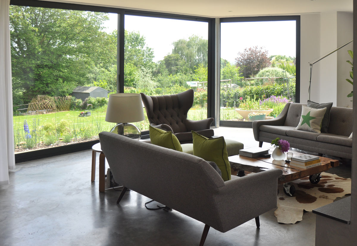 Bay Window Extension with Stunning views to Garden ArchitectureLIVE Modern living room bay window,extension,grey sofa,grey chair,green accent,concrete flooring,polished concrete,full height window
