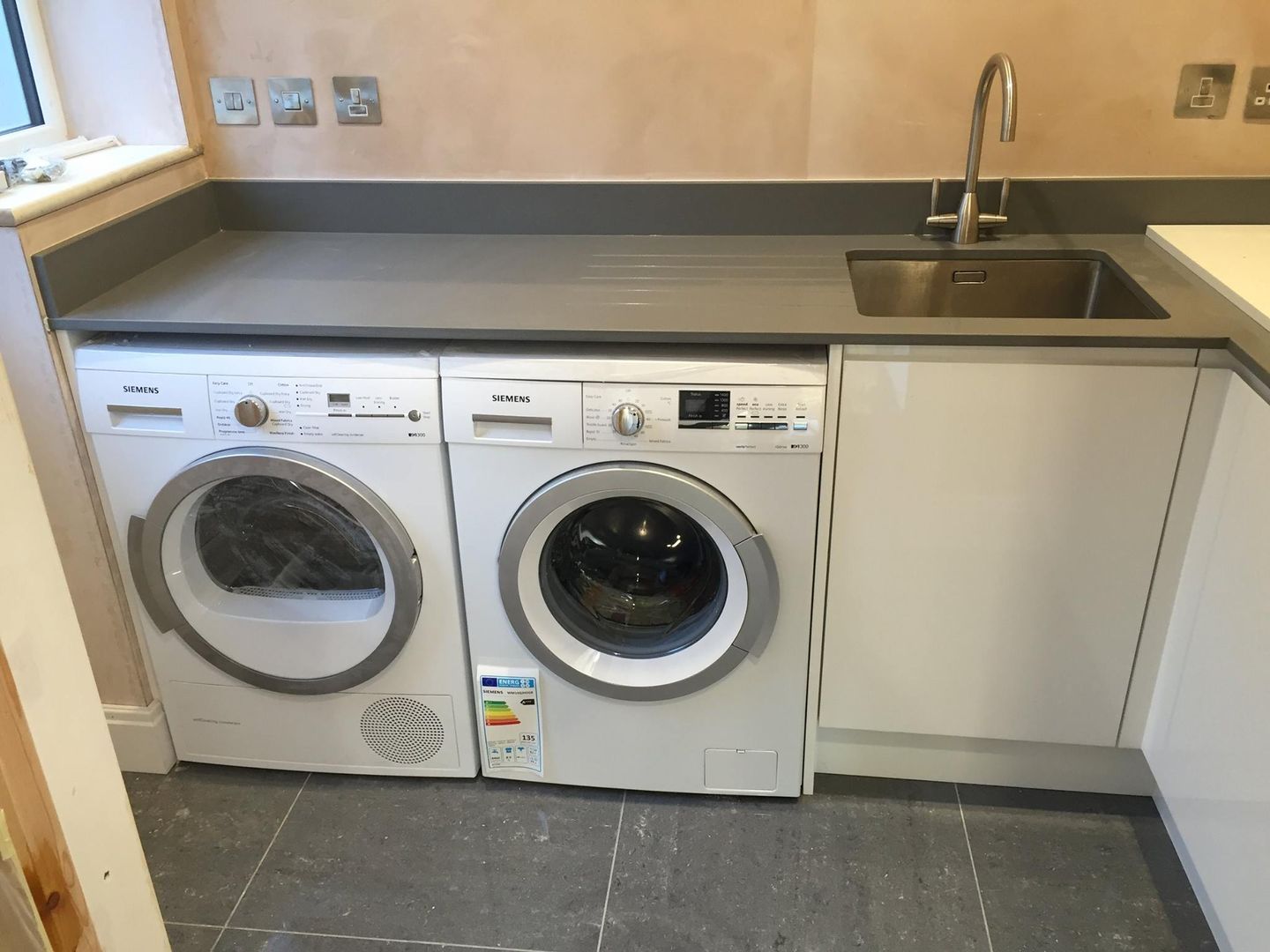 Utility Area with Washing Machine, Tumble dryer and Sink Meridien Interiors Ltd Modern Kitchen