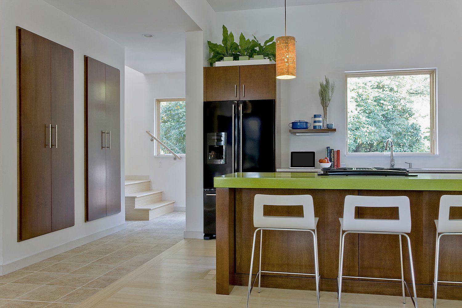 Kitchen island, floating pantry, and stairs to second level ZeroEnergy Design Kitchen