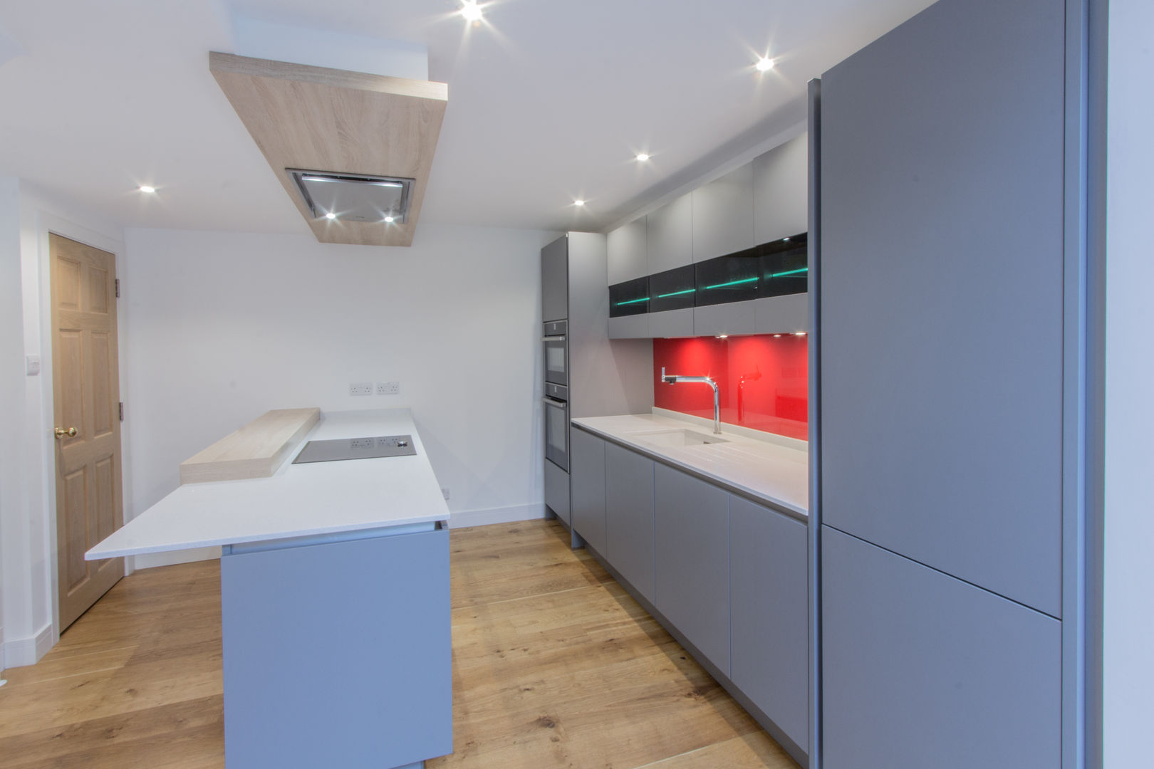 Grey & Red Eco German Kitchens Modern kitchen MDF Nobilia,Twinkle White worktops,Neff oven,Neff combination microwave,Blanco sink and tap,Neff Induction hob,open plan galley style kitchen,glazed wall units