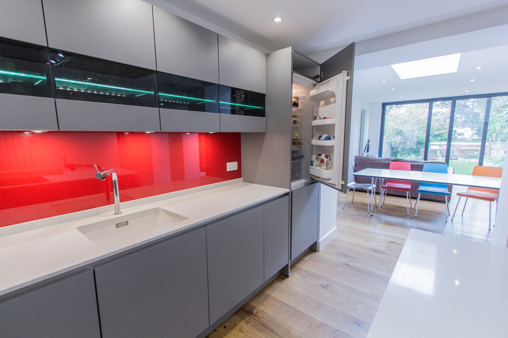 Grey & Red Eco German Kitchens Dapur Modern MDF Nobilia,Twinkle White worktops,Neff oven,Neff combination microwave,Blanco sink and tap,Neff Induction hob,open plan galley style kitchen,glazed wall units