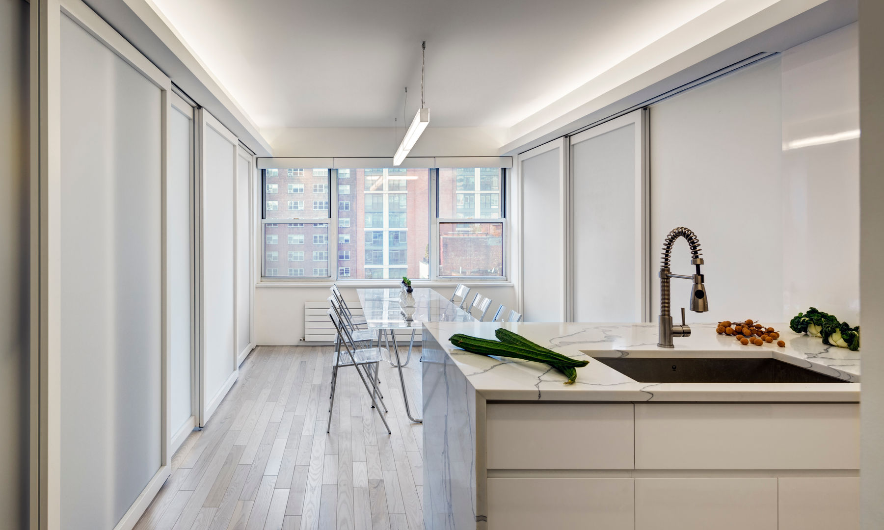 Open Plan Kitchen with Sliding Doors in Closed Position Lilian H. Weinreich Architects Dining room