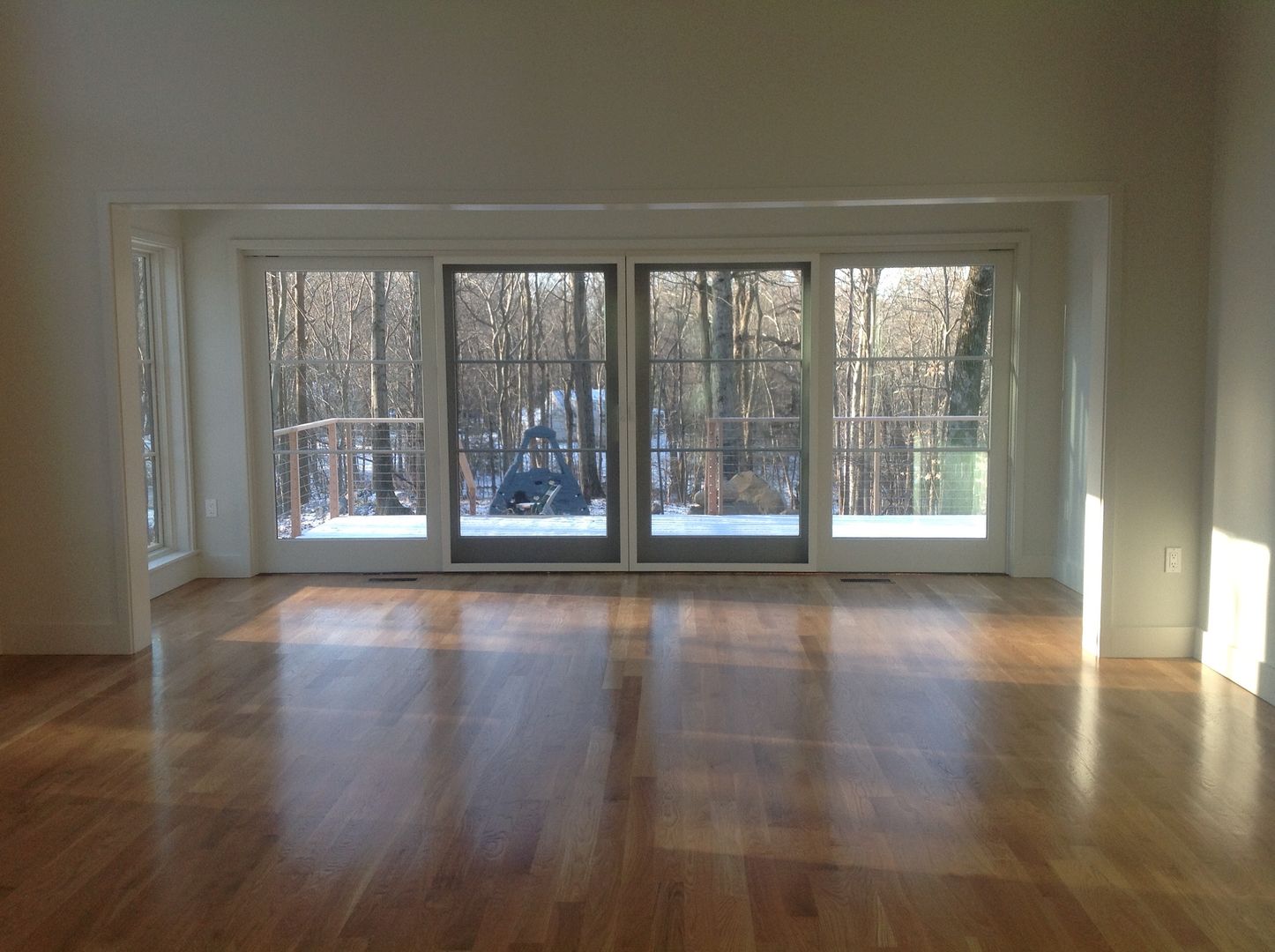 view through the living room to outside JMKA architects Modern Media Room pellawindows,,newhouse,wideplankfloors