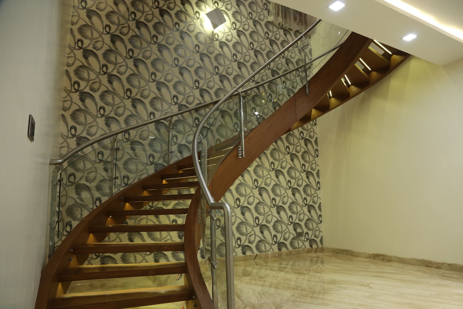 A curved wood clad metal stair with lights homify Modern corridor, hallway & stairs