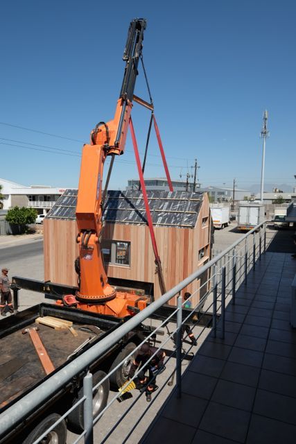 Hoisting the pod house onto the truck. Greenpods