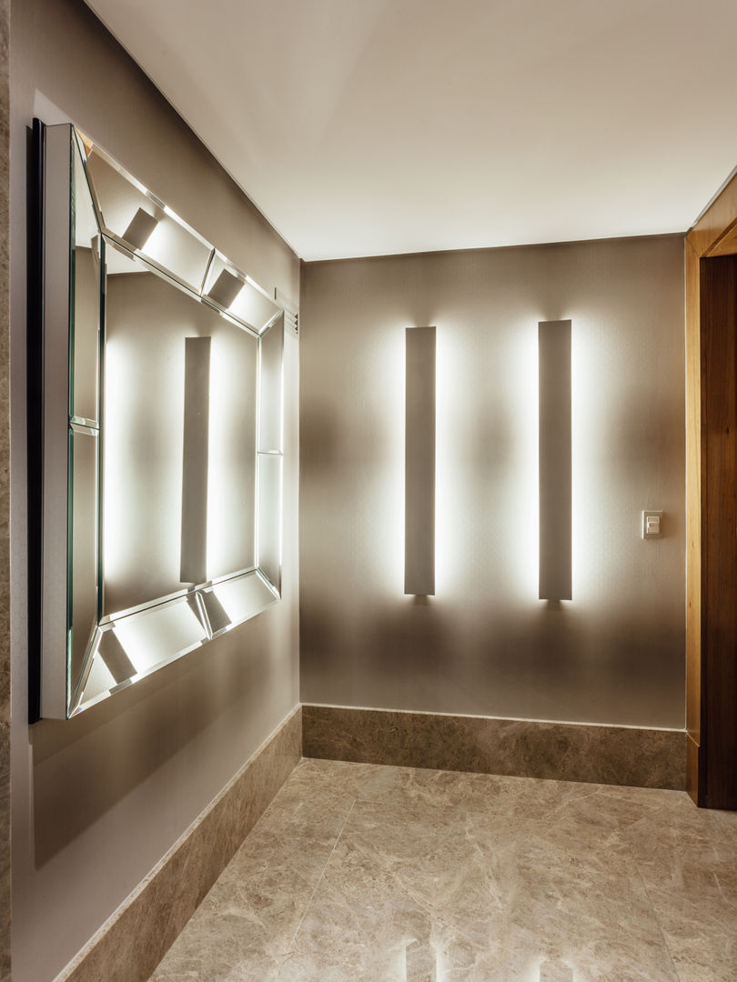 Elegant hallway with illuminated wall sconces and large mirror