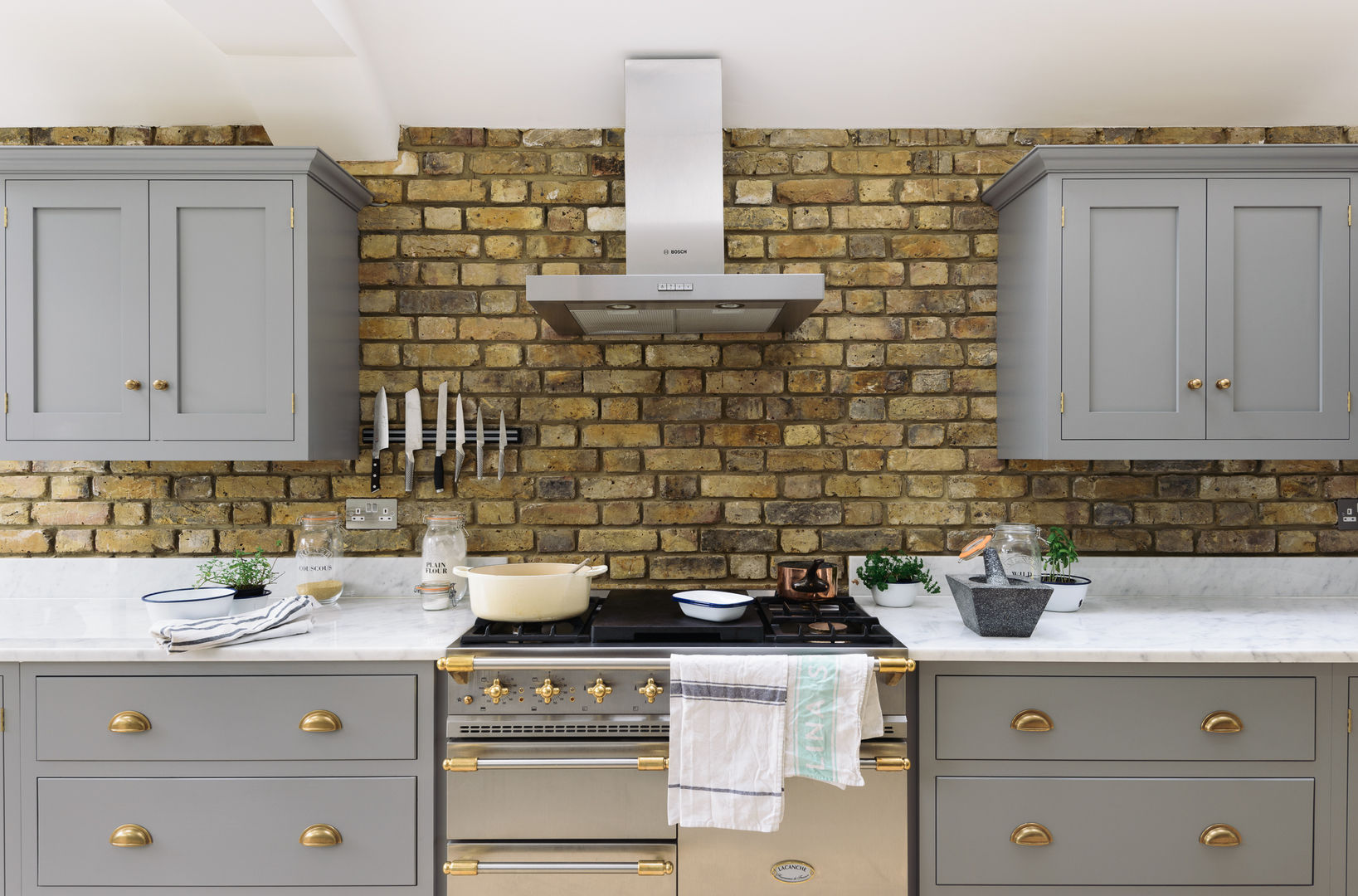 The SW12 Kitchen by deVOL deVOL Kitchens مطبخ خشب Wood effect stainless steel,range cooker,lacanche,extractor,exposed brick,brick wall,grey kitchen,grey cupboards,brass hardware,home,kitchem,style,Cabinets & shelves