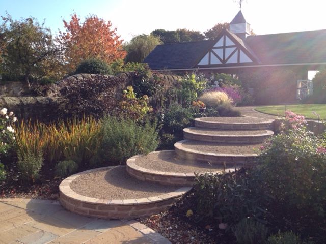 A Cheshire Country Garden Charlesworth Design Country style garden steps,lawn,patio,herbaceousplanting,gardenbuilding,gardenroom,circular steps