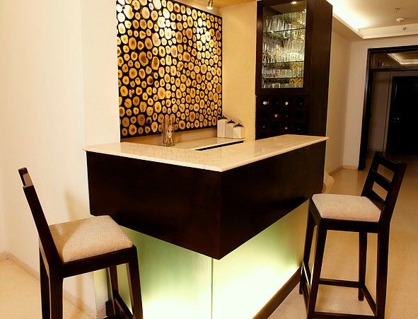 An apartment in Palm springs, Gurgaon, stonehenge designs stonehenge designs Modern wine cellar Table,Furniture,Building,Chair,Interior design,Lighting,Wood,House,Flooring,Floor