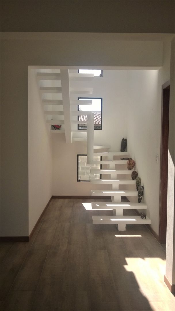 homify Modern corridor, hallway & stairs Concrete