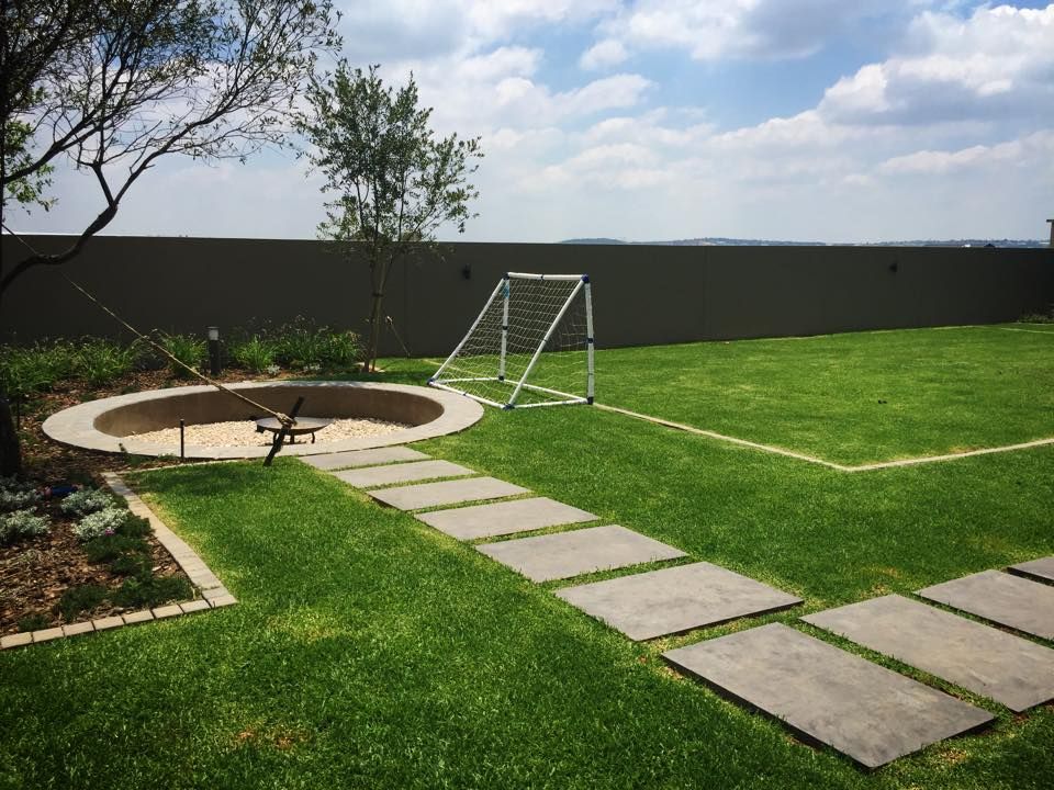 Fire pit and soccer pitch Acton Gardens Modern Garden