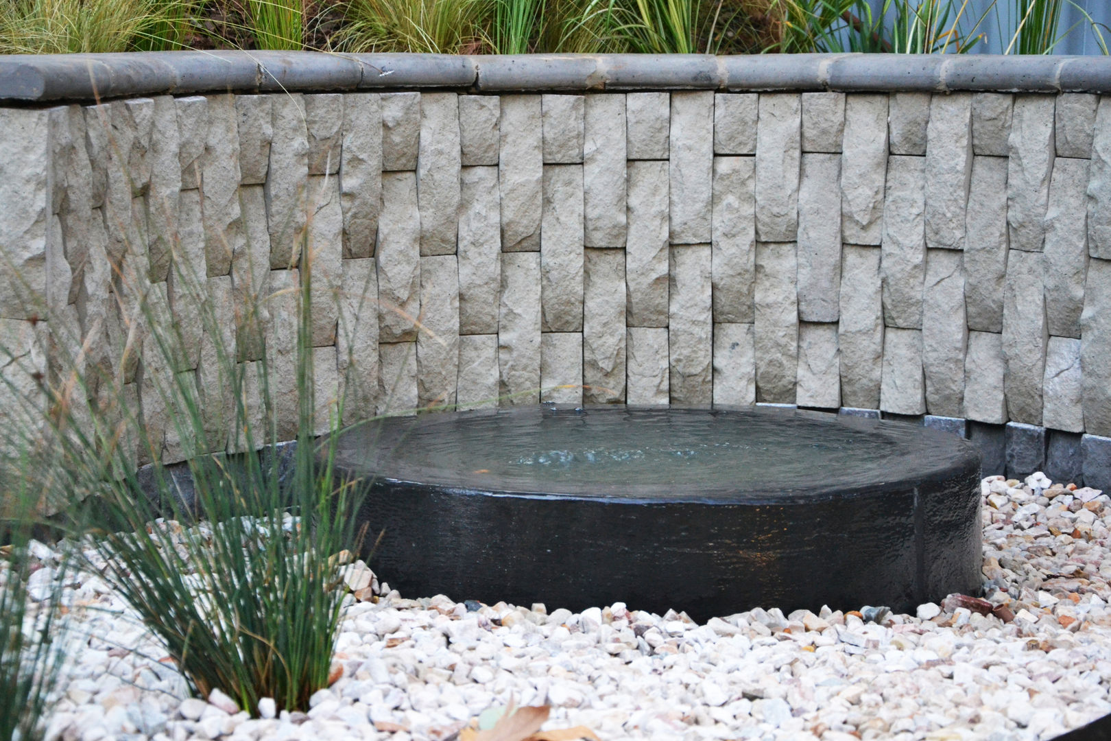 Water feature and bog garden Acton Gardens Industrial style garden Concrete