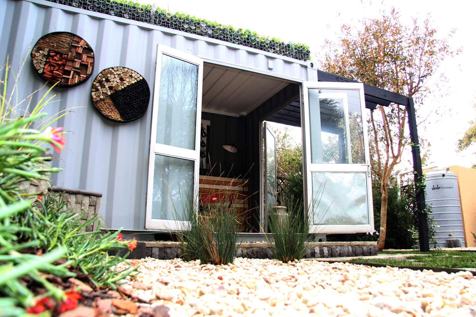 Roof garden on container home Acton Gardens Industrial style houses Metal insulation,container living,shipping container,roof garden,gabions,recycle
