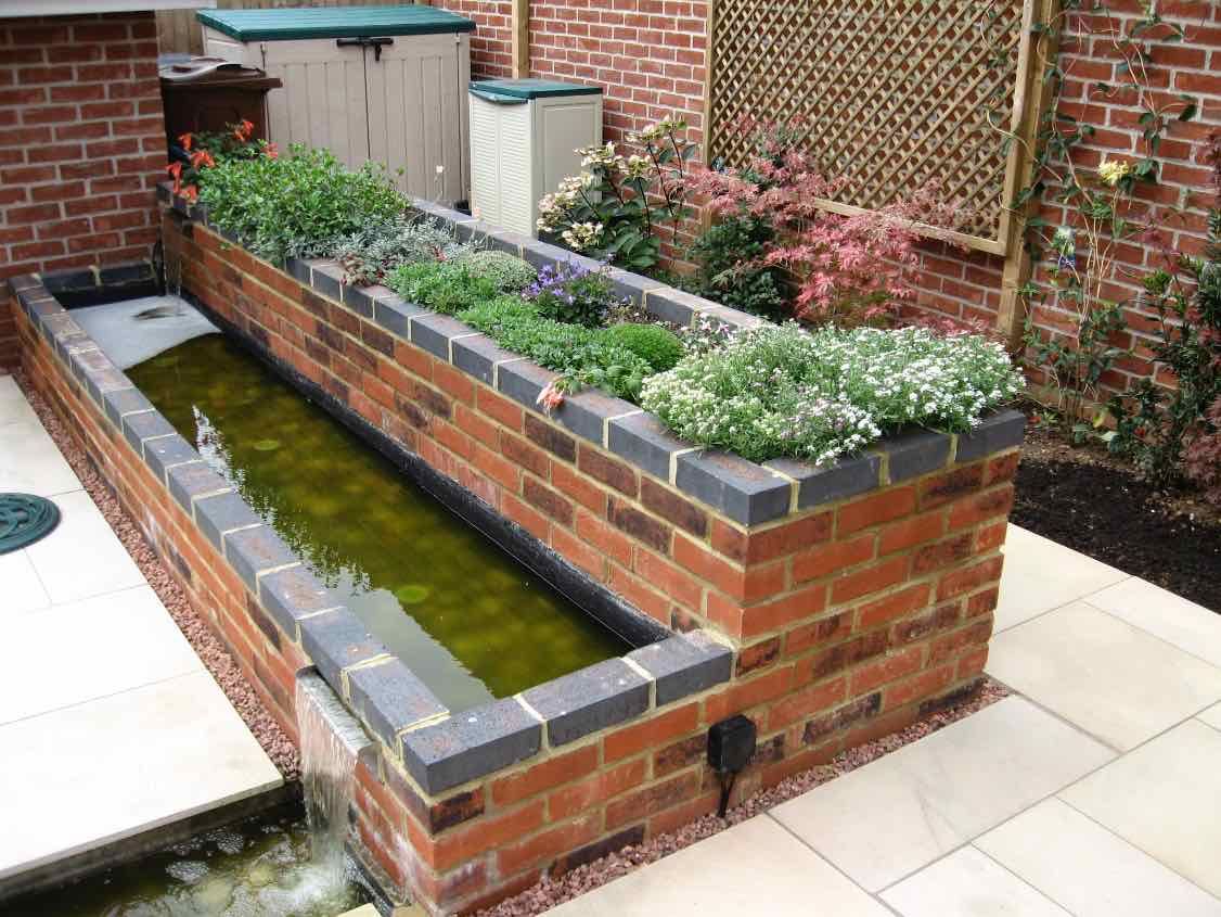 Raised bed and water feature Jane Harries Garden Designs Modern Garden Bricks