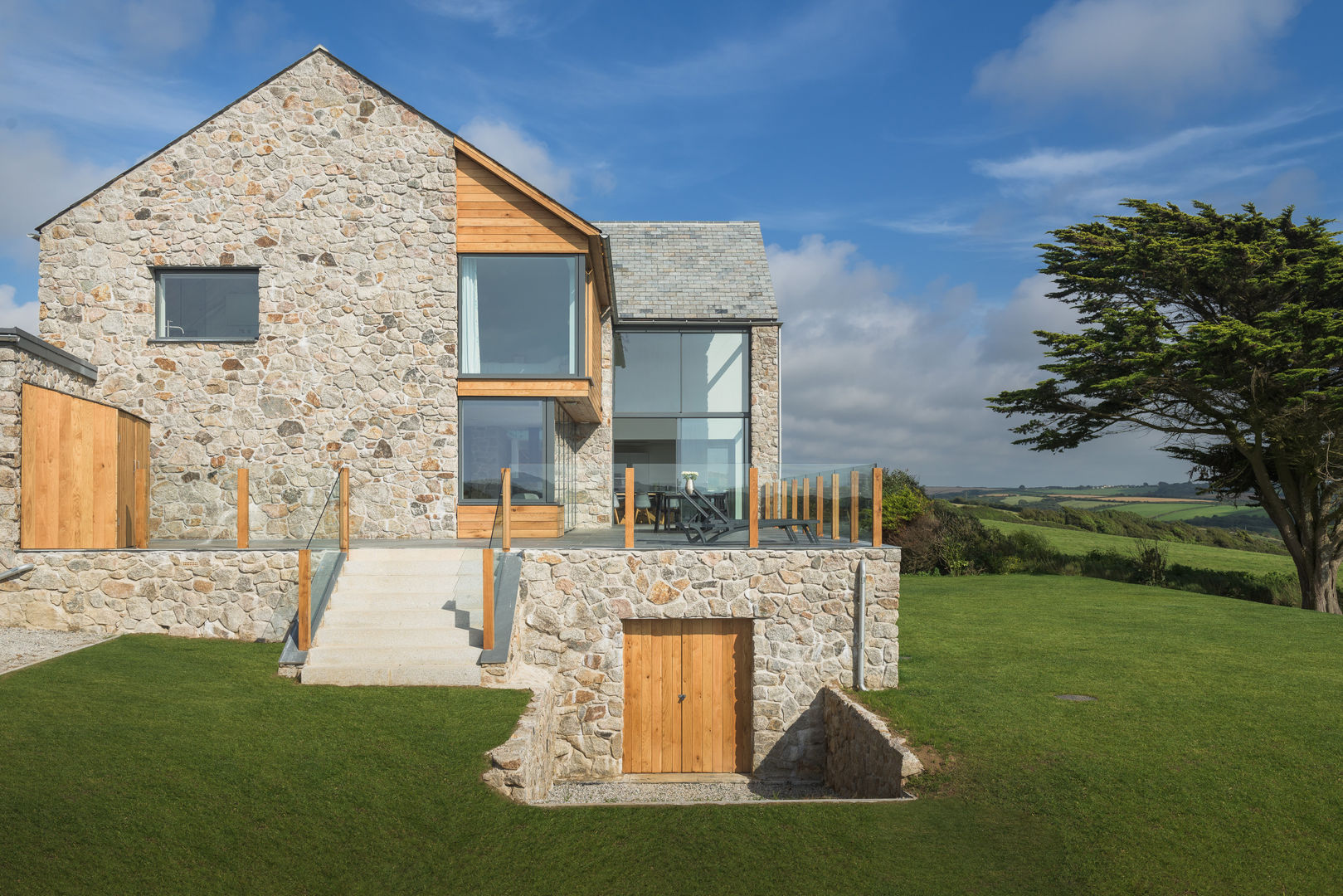 Contemporary Replacement Dwelling, Cubert, Laurence Associates Laurence Associates Maison individuelle Granite exterior,granite,cladding,garden,windows,elevation,glazing,full height glazing,natural materials,lawn,exterior steps