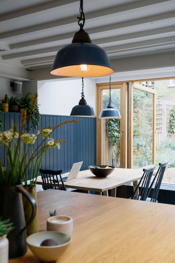 View across kitchen to dining room Mustard Architects Їдальня timber panelling,industrial lighting,exposed joists,integrated bench,house plants,oak table,spindle chairs,oak worktop