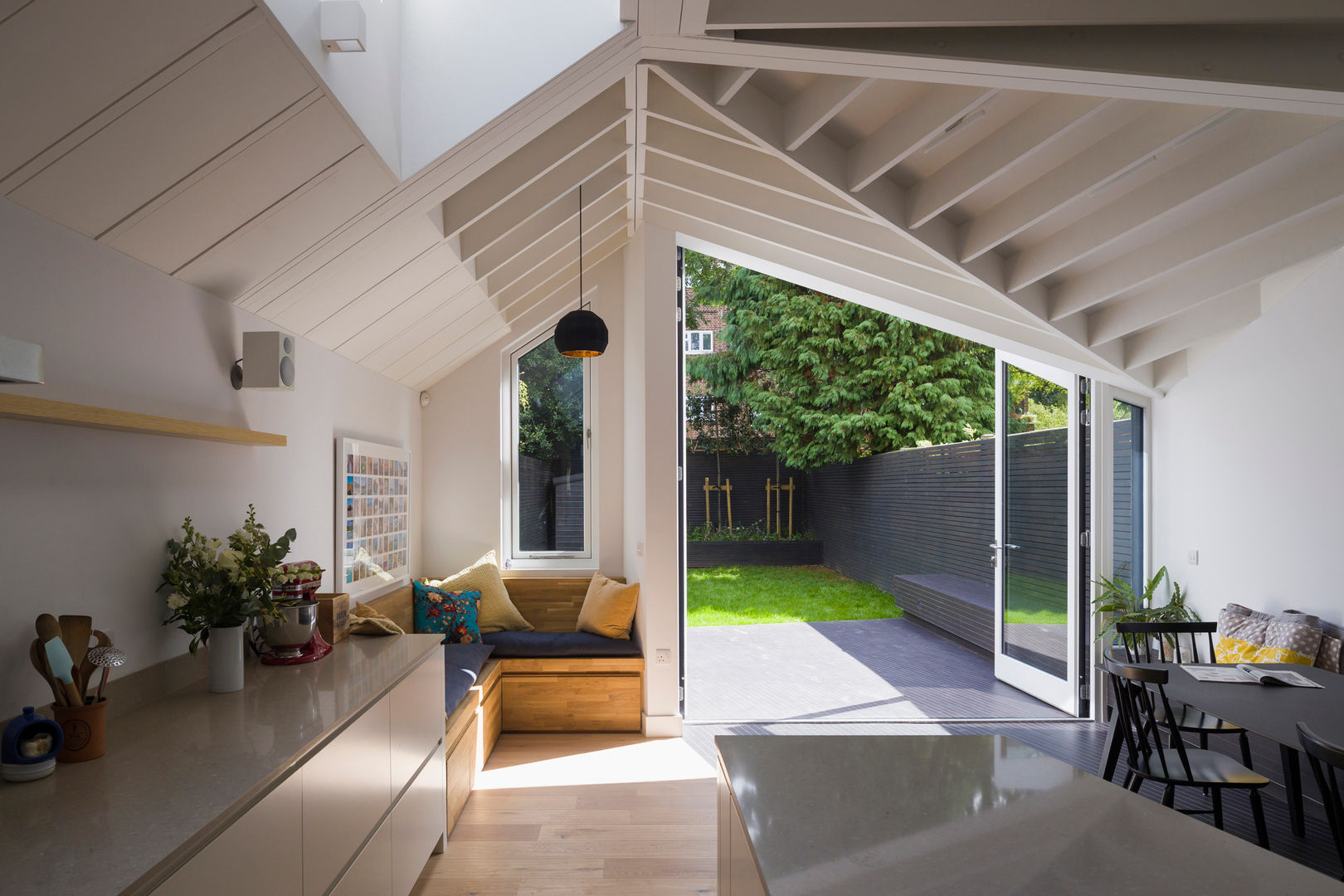 View of bench and garden from kitchen Mustard Architects Built-in kitchens kitchen,bench,exposed joists,oak floor,rooflight,skylight,angled roof,tapered roof,oak bench,rear extension,painted timber